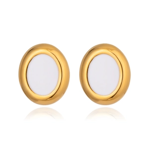 Macro shot of oval gold earrings with white inlay and polished stainless steel finish