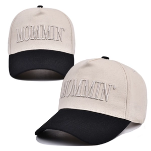 Detailed embroidery of MOMMIN' text on a two-tone cotton baseball cap with curved brim