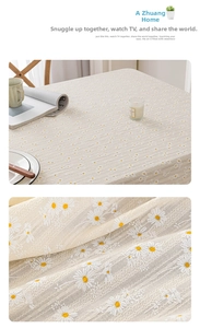 Close-up of daisy embroidery and scallop lace edge on apricot linen blend tablecloth