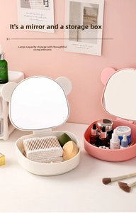 Close-up of folding makeup mirror storage box with cute bear ears for desk organization