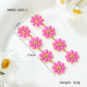 Macro detail of long pink daisy drop earrings with gold chain links and 5.9cm size label