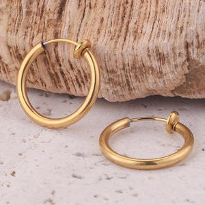 Golden invisible spring clip-on earrings for non-pierced ears on natural stone background