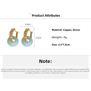 Detail view of jade-like round earrings with dimensions 2.3x1.4cm and gold plating