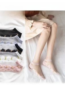 Detailed view of floral sheer glass silk socks in five colors with scalloped edges