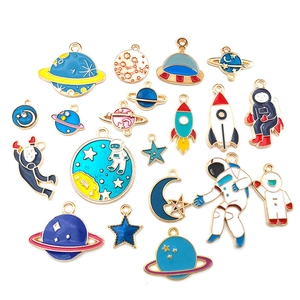 Collection of 18 astronaut and space theme enamel pendants with gold metal plating