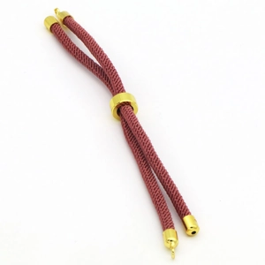 Detail of adjustable red-brown braided cord bracelet with polished gold metal sliding beads