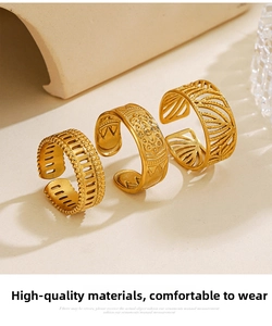 Detail of three 18K gold plated stainless steel rings with intricate cutout leaf patterns