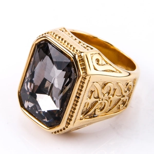 Detailed close-up of a vintage gold ring featuring a large faceted dark grey gemstone