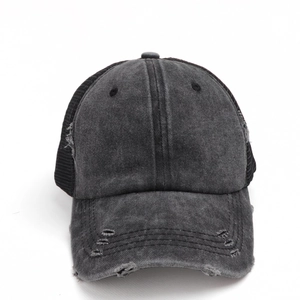 Front view of washed cotton mesh trucker hat with distressed ripped detailing in charcoal