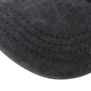 Close-up of black washed cotton baseball cap with four rows of parallel stitching on the brim
