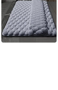 Detailed close-up of gray memory foam bath mat with soft 3D pebble embossed texture