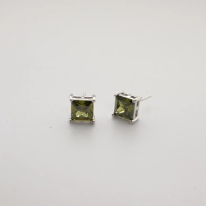 Close-up of olive green square-cut zircon earrings set in 925 silver four-prong mount