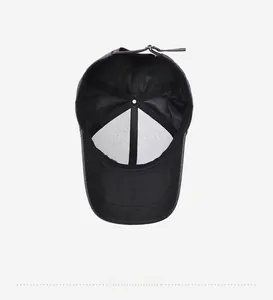 Detail of black baseball cap interior with stitching, sweatband, and bronze buckle