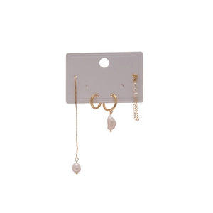 French style four-piece gold earring set with freshwater pearls on white display card