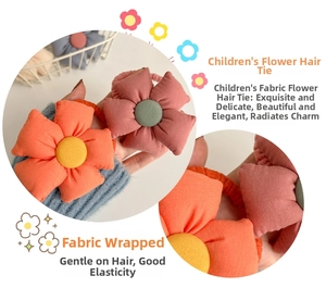 Close-up of cute fabric sunflower hair ties in orange and pink for little girls