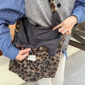 Detailed interior of leopard print plush tote bag with magnetic closure and inner pocket