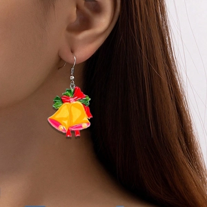Enamel Christmas bell earrings with red bows worn by model for festive holiday party