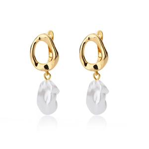 Macro detail of geometric golden metal ring with irregular freshwater pearl drops