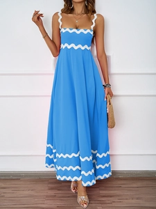 Detail view of blue maxi dress featuring elegant white ric rac trim and wavy accents