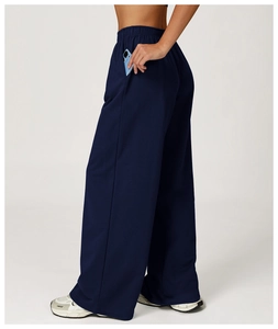 Detail of side pocket on high-waist navy wide-leg sports sweatpants showing storage capacity