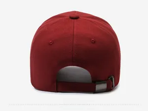 Detail view of the deep red cotton baseball cap with an adjustable metal buckle strap