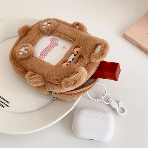 Detailed macro view of plush brown bear coin purse with clear ID window and zipper