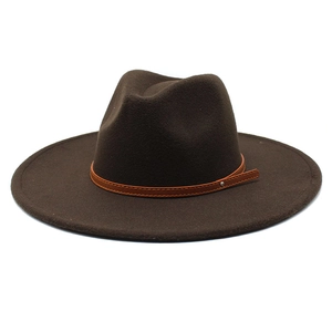 Detail of dark brown wool fedora with wide brim and elegant leather strap buckle