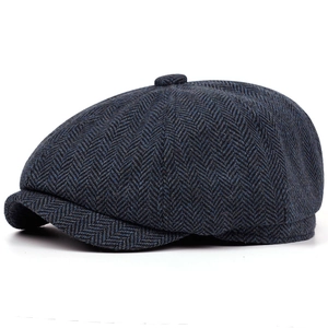 Detail of navy blue herringbone newsboy cap with classic thick tweed wool texture