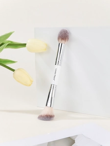 Detailed view of dual-ended makeup brush with soft gradient bristles and silver ferrule