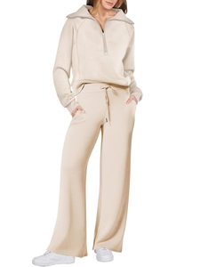 Detail of beige wide-leg pants and zip-up collar sweatshirt in soft knit fabric