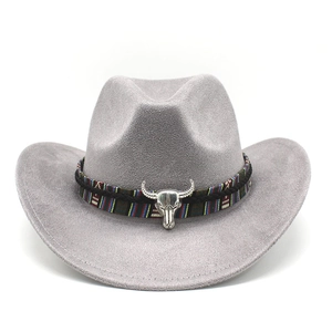 Detail of grey suede cowboy hat featuring tribal pattern band and silver bull skull ornament