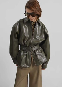 Army green faux leather jacket with belt detail showing soft texture and glossy finish