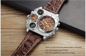 Detail view of Oulm multi-timezone watch with brown leather strap on wooden desk