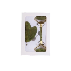 Green jade facial roller and gua sha set in a white windowed gift box on white background