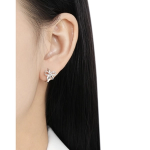 Elegant S925 sterling silver bow knot hoop earrings worn by a model on white background