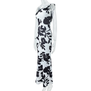 Side view of white slim-fit dress featuring bold black floral print and one-shoulder cut