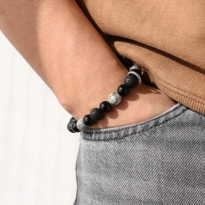 Men's adjustable 8mm beaded lava and map stone bracelet with metal charm on wrist