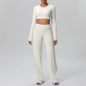 Detail view of cream white long sleeve crop top and high waist wide leg yoga pants set