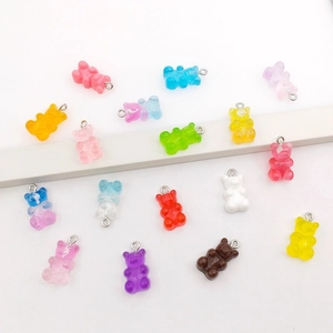 Close-up of colorful resin gummy bear charms with metal loops for DIY jewelry making