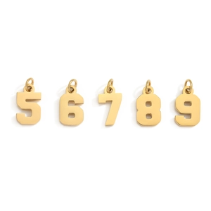 Detailed view of gold stainless steel number charms 5 to 9 for DIY jewelry making
