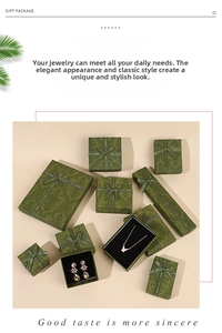 Detailed view of vintage green paisley jewelry gift boxes with silk ribbon bows