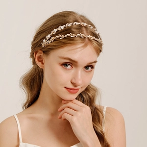 Detail view of a golden double-layered leaf headband with elegant crystals and pearls