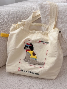 Off-white nylon tote bag with cartoon dog embroidery and adjustable drawstring closure