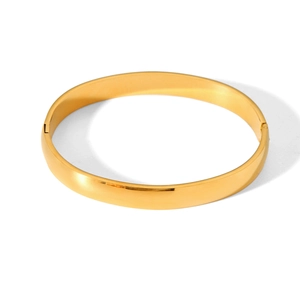 Detailed view of gold minimalist bangle with a polished finish and a functional hinge lock