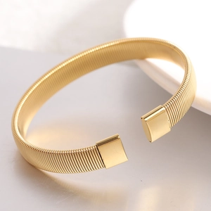 Macro view of 6mm gold stainless steel wire bracelet showing detailed mesh texture