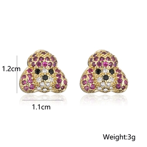 Detail view of gold-plated poodle earrings with pink and white cubic zirconia stones
