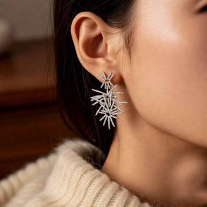 Detail of silver firework stud earring with sparkling zircons worn by a model