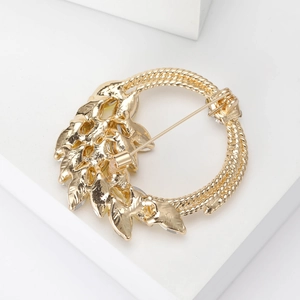 Elegant gold wheat ear brooch pin for suits featuring a twisted ring and textured leaf