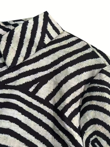 Close-up of black and white striped shirt collar showing detailed fabric texture and stitching
