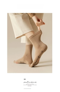 Detail of five-toe socks with acupoint mapping on the sole in warm khaki cotton